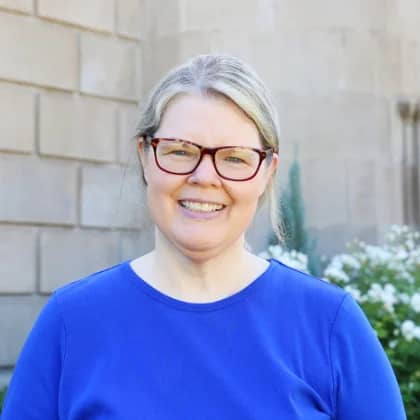 a person wearing glasses smiling