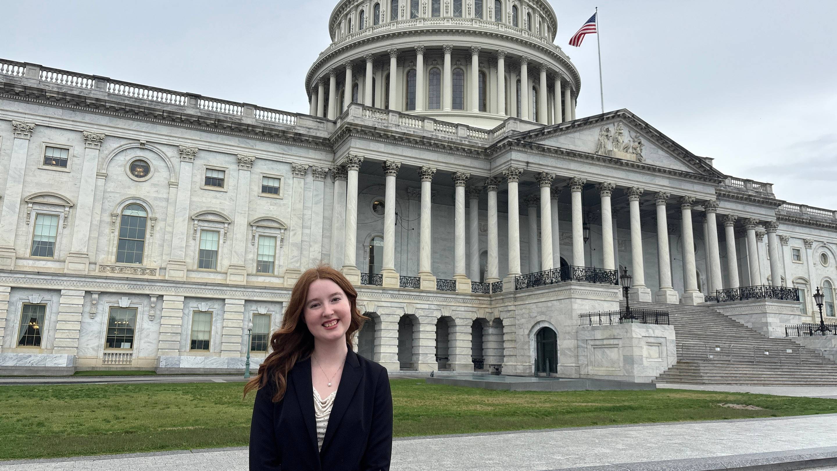 a person standing in front of a large white building