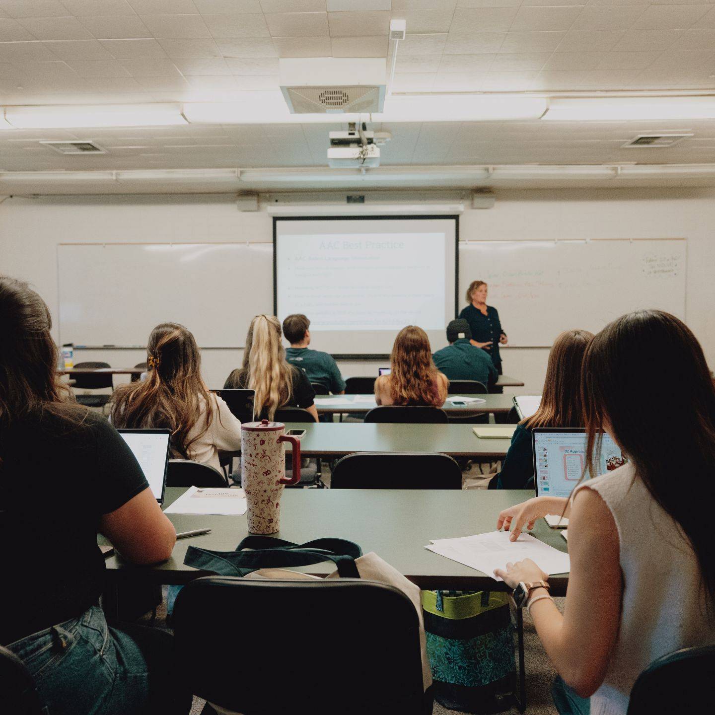 a group of people sitting in a classroom