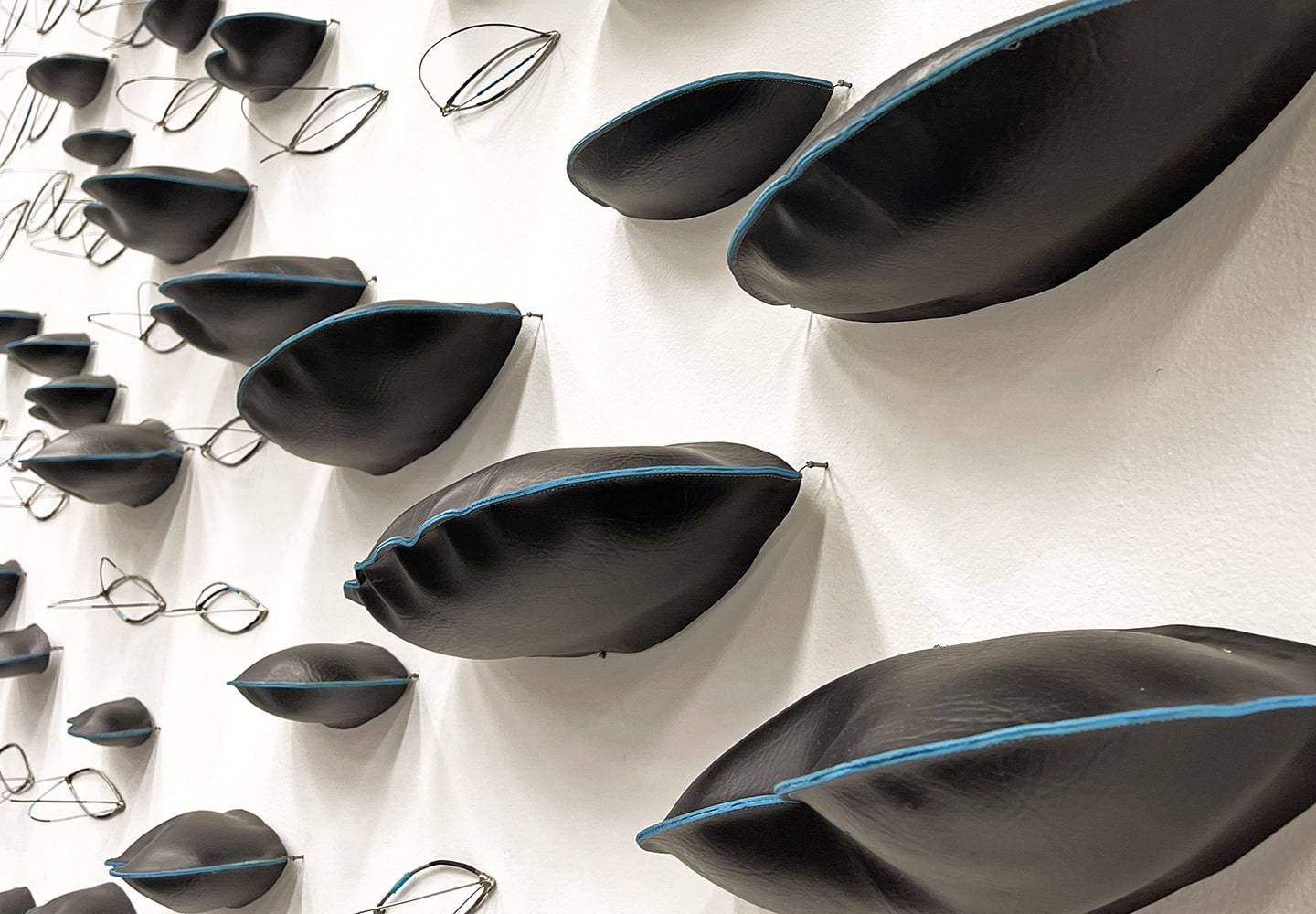 a wall with black pillows