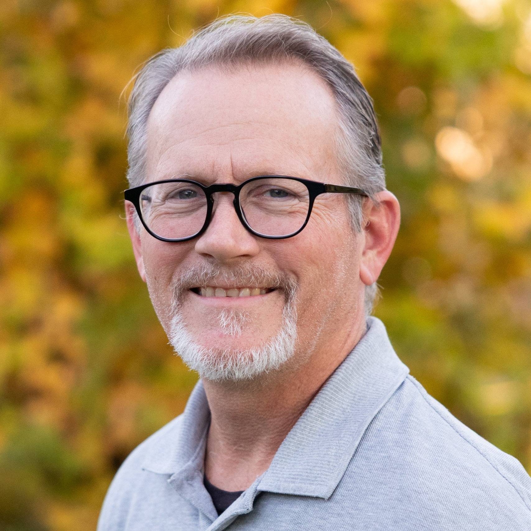 a person with glasses and a beard