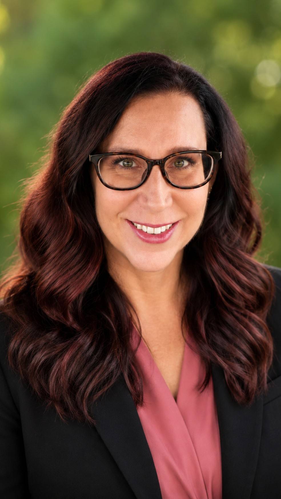 a person wearing glasses and smiling