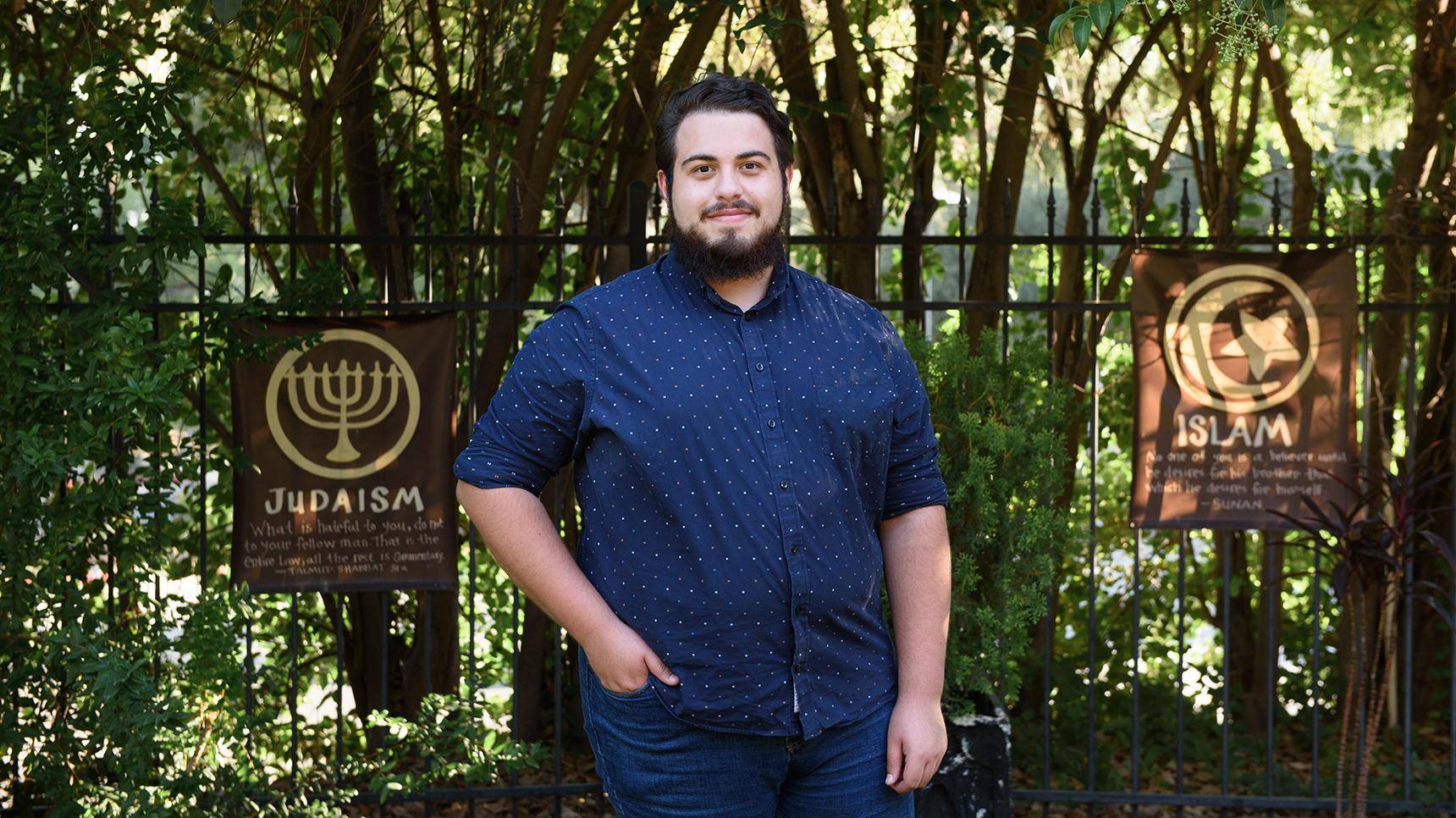 a person standing in front of a fence