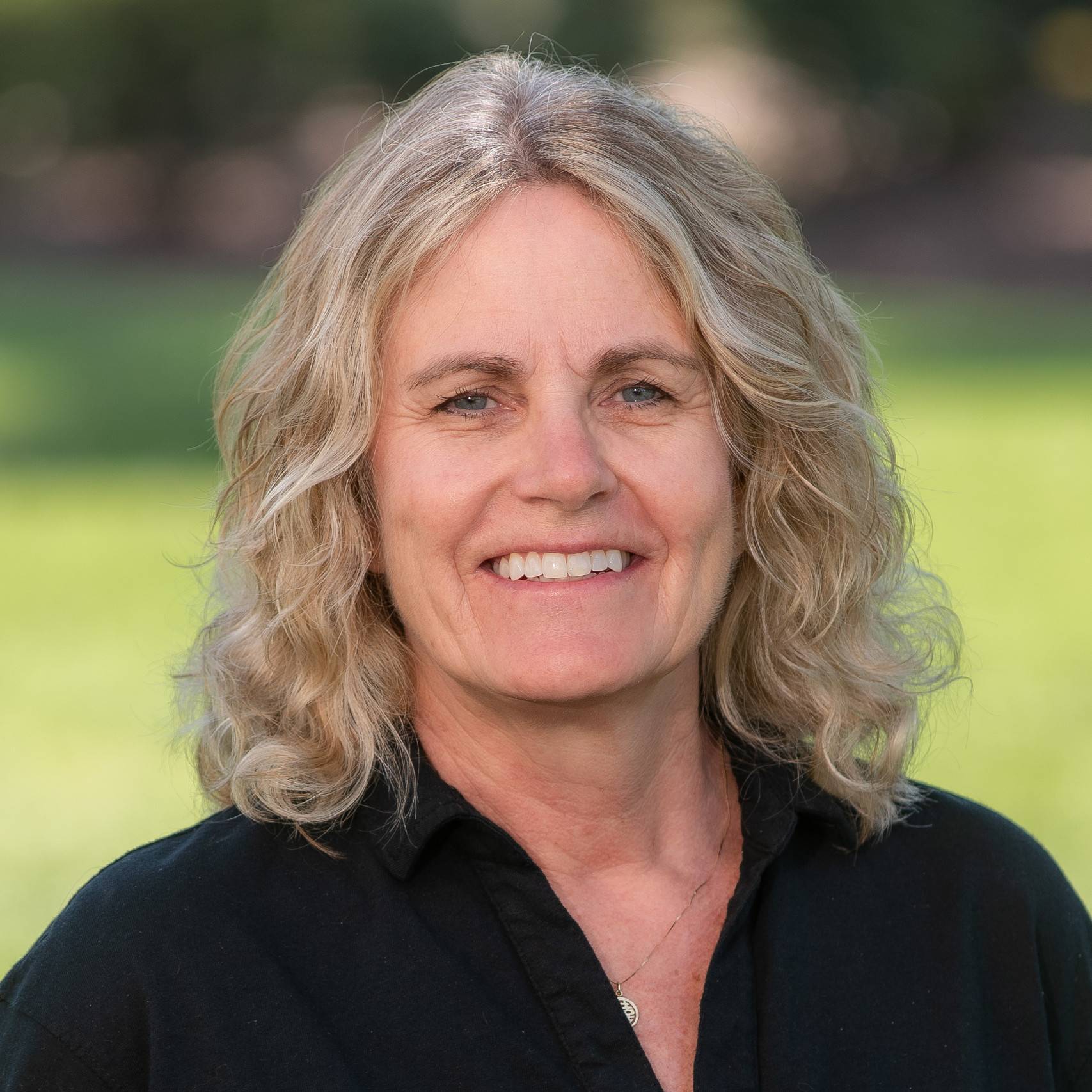 a person with blonde hair smiling