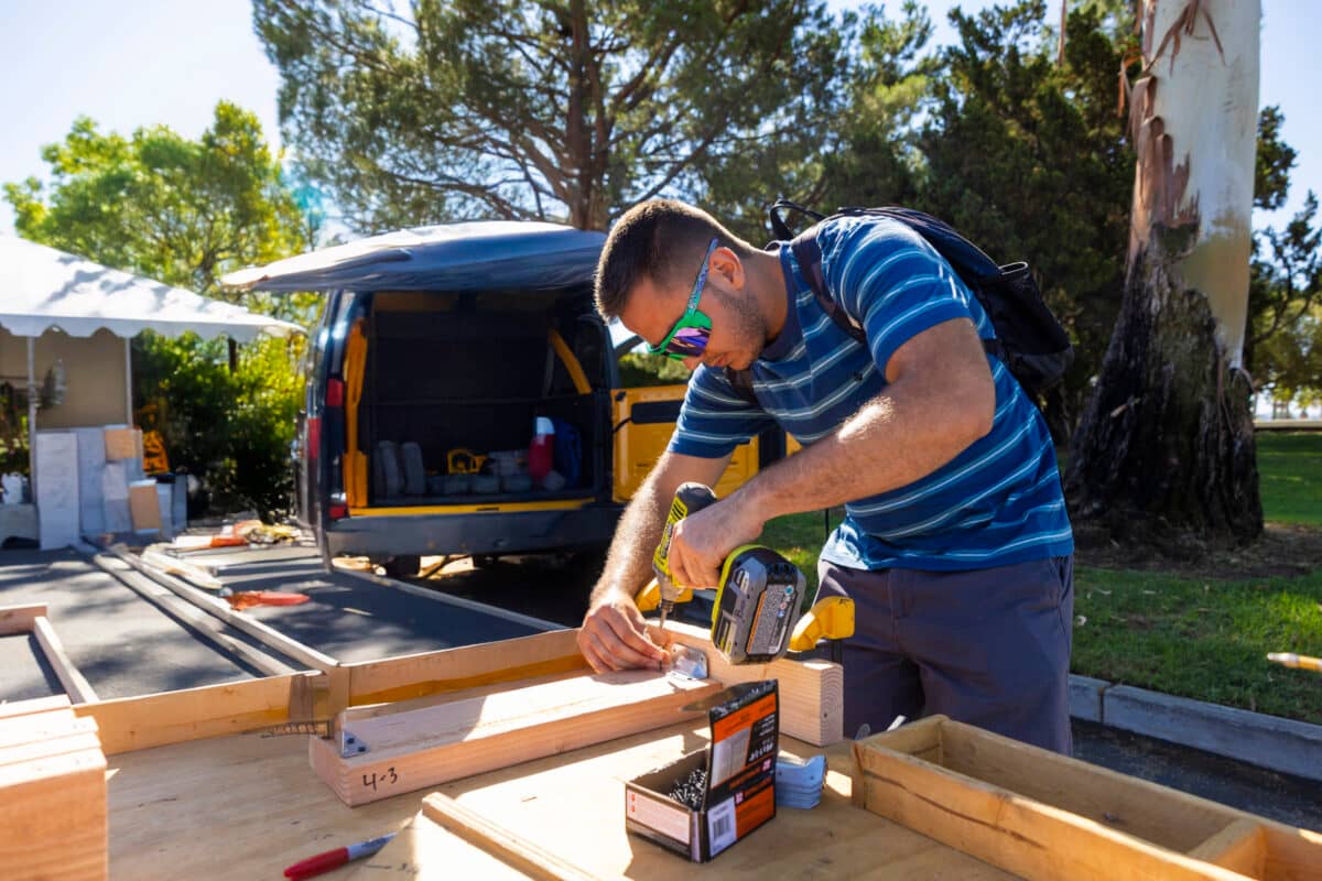 a person using a drill to drill wood