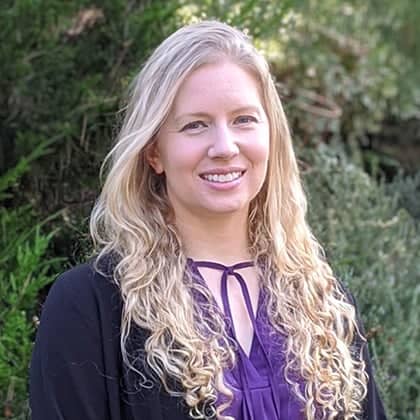 a person with long blonde hair smiling
