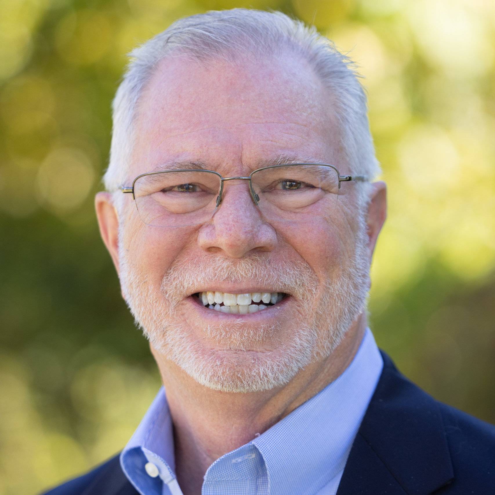 a person with glasses smiling