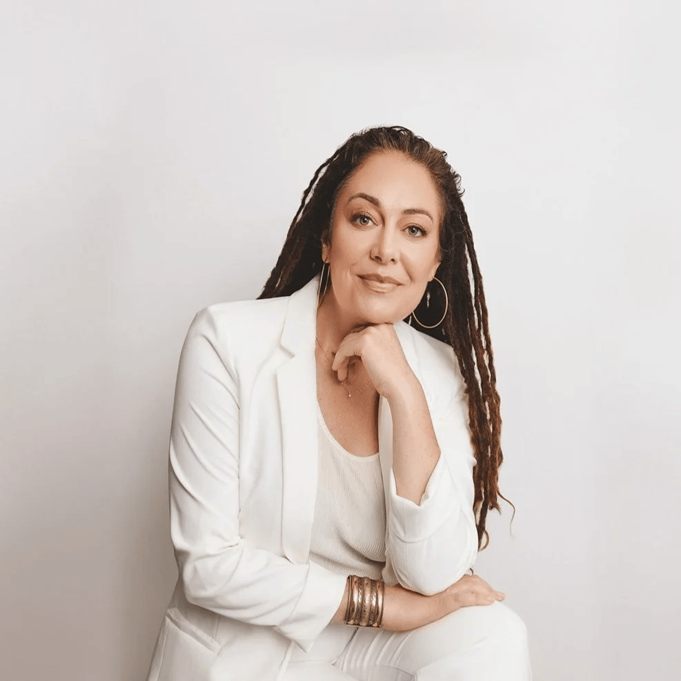a person in white suit with long dreadlocks