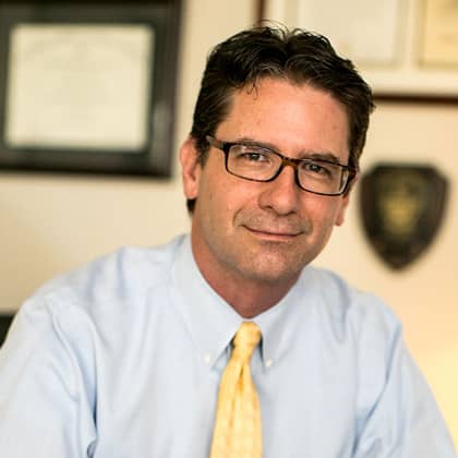 a person wearing glasses and a blue shirt