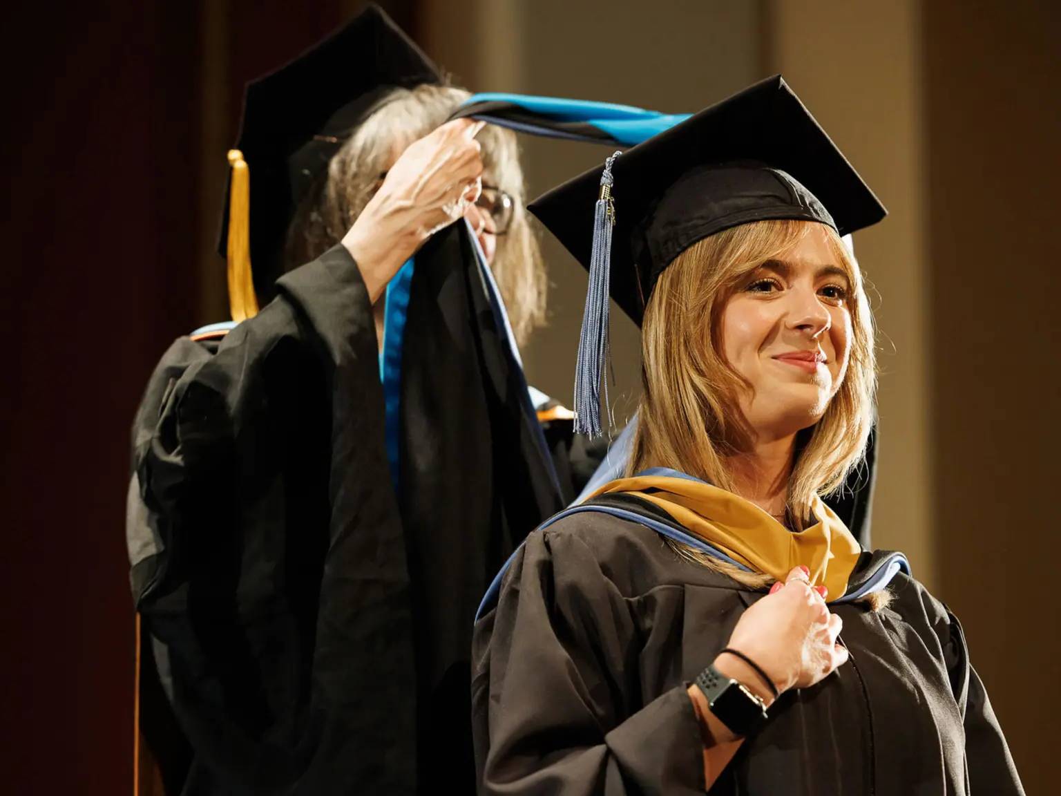 a person in a graduation gown and cap