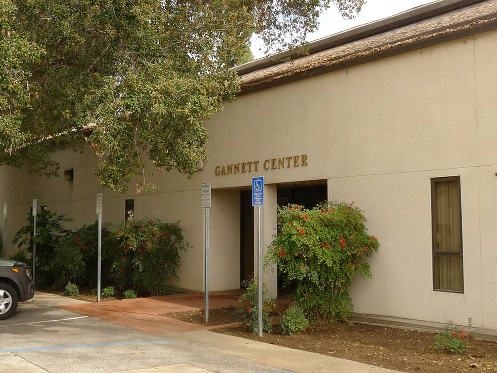a building with a sign and trees