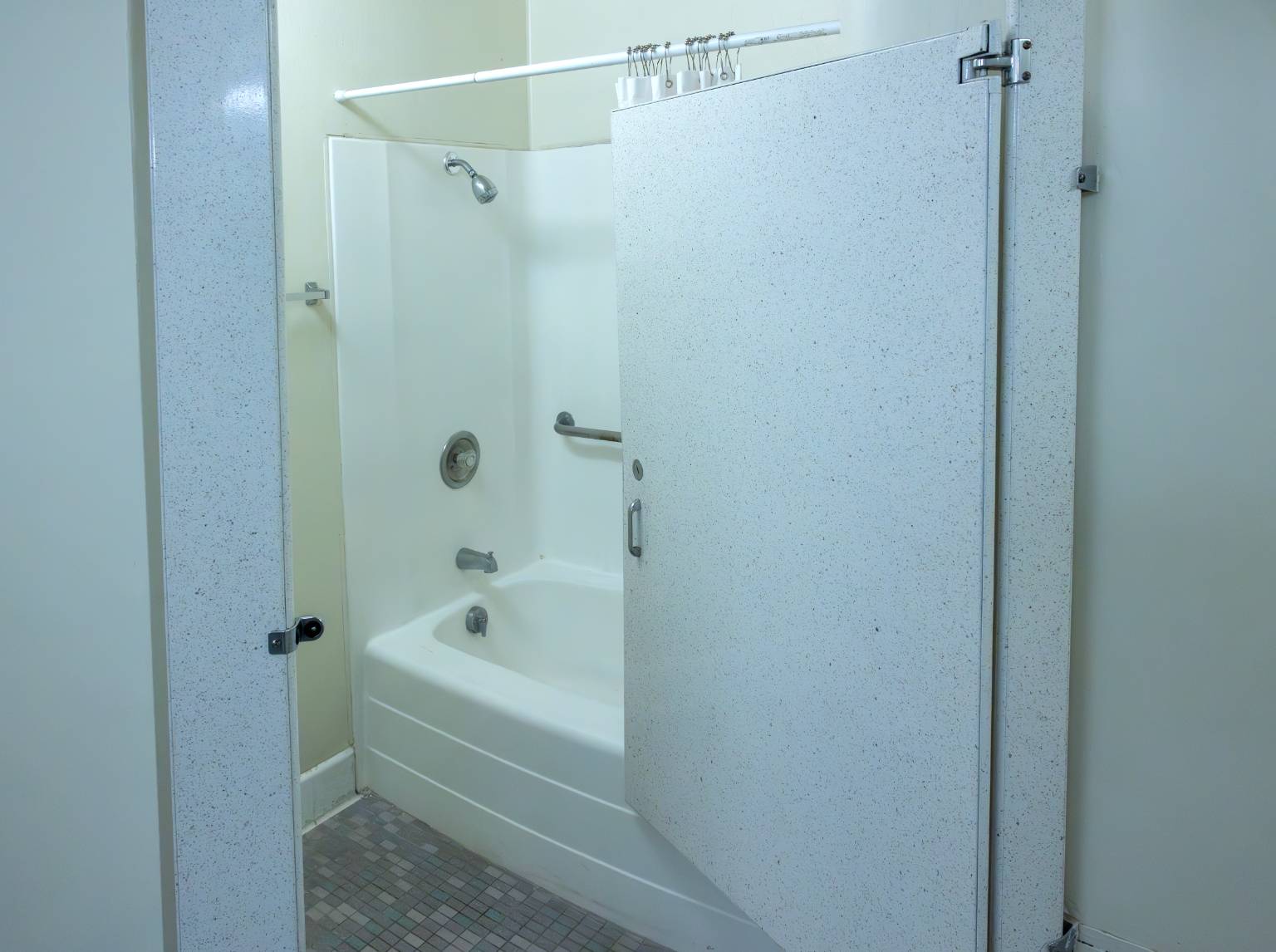 a shower stall with a door open