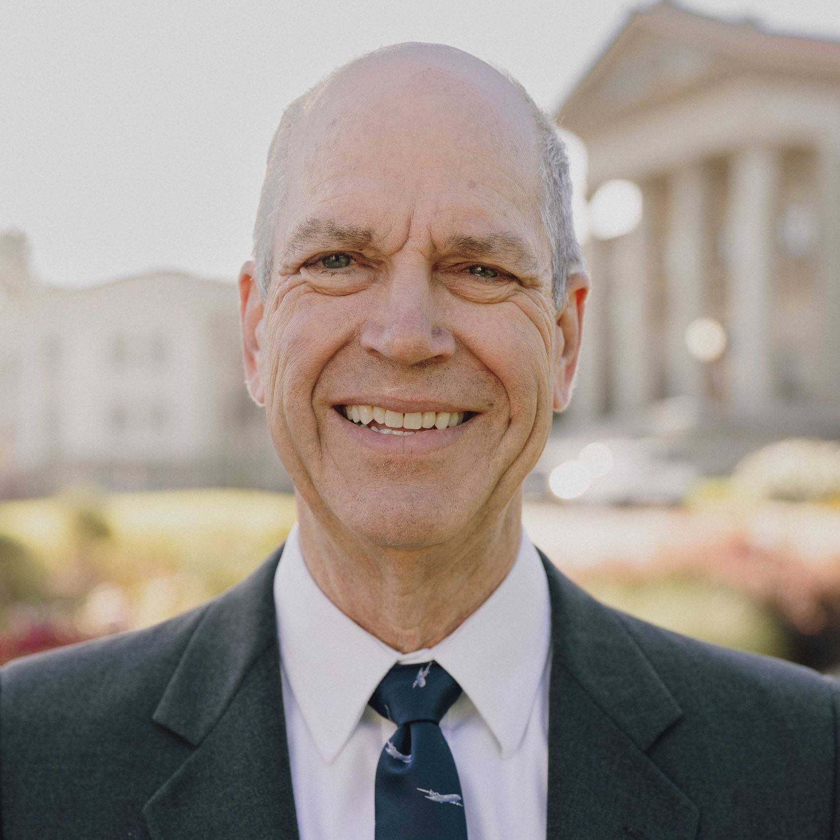 a person in a suit smiling