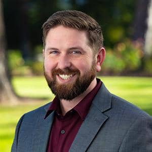a person with a beard smiling