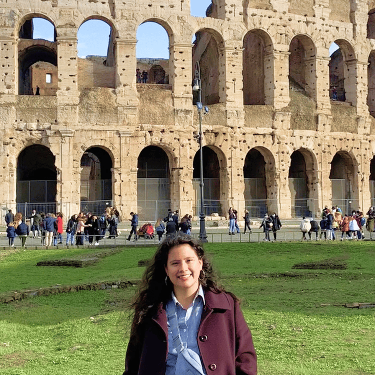 a person standing in front of an ancient building