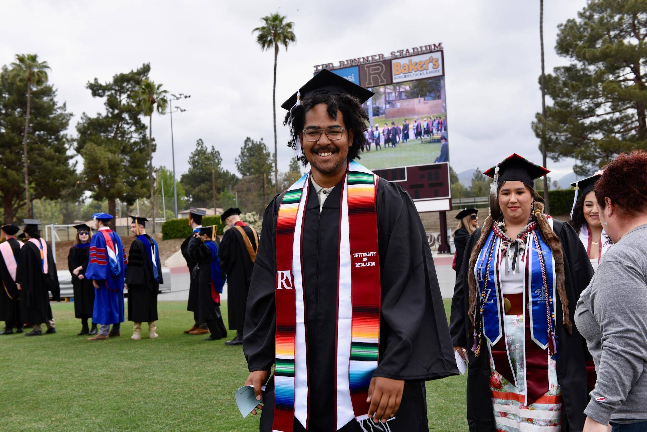 a person and person in graduation gowns and caps