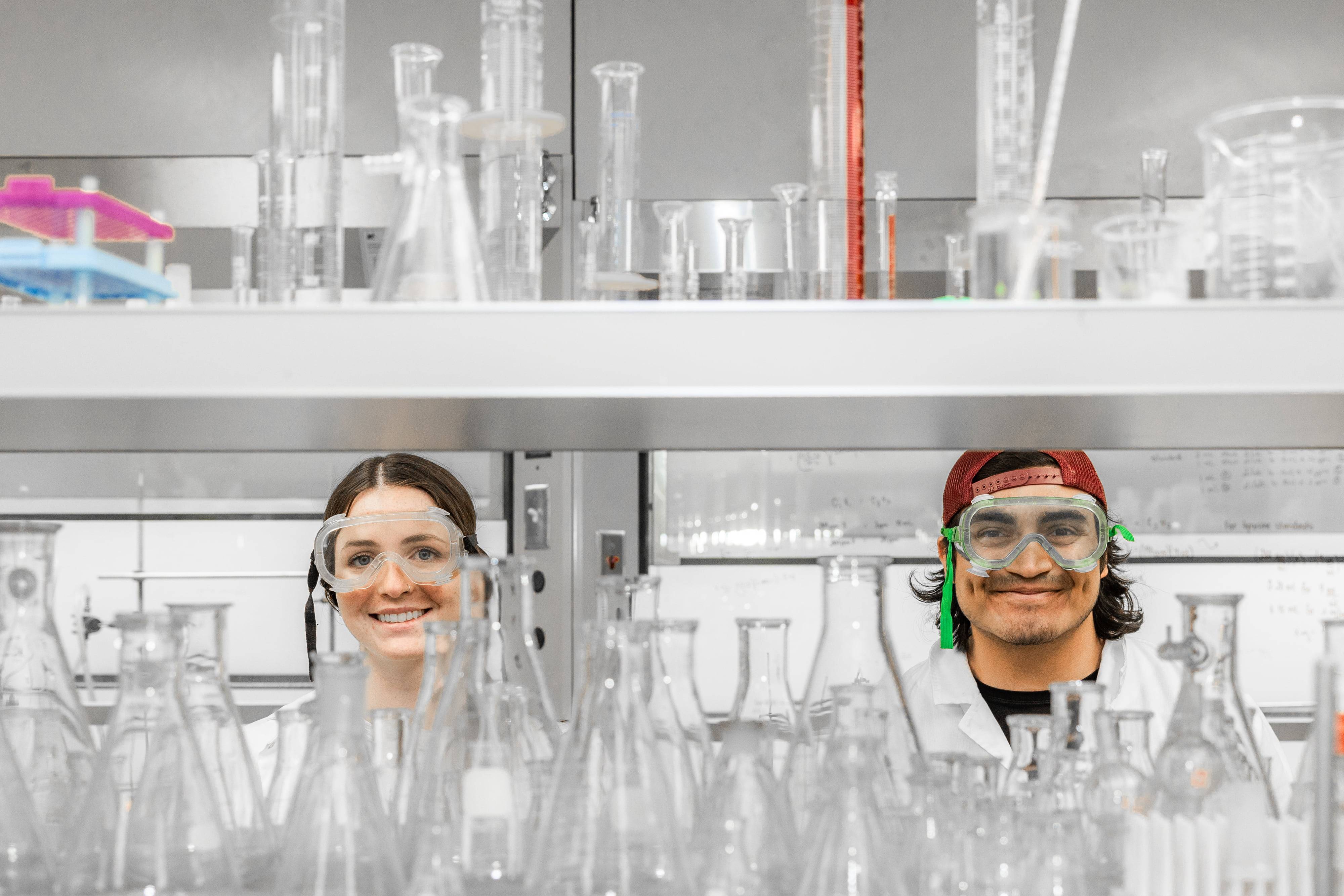 a person and person in lab coats and goggles