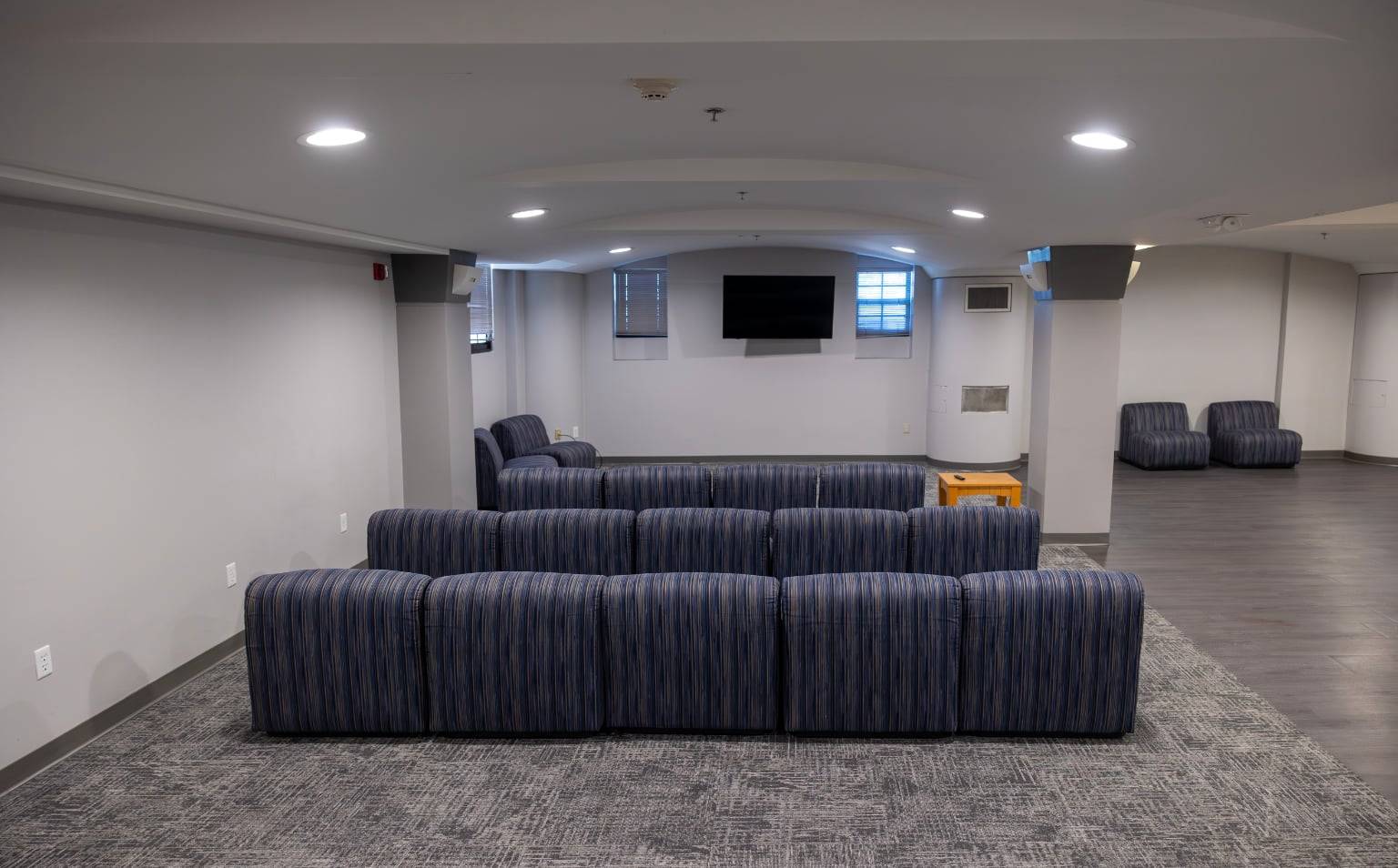 a room with blue and white striped couches