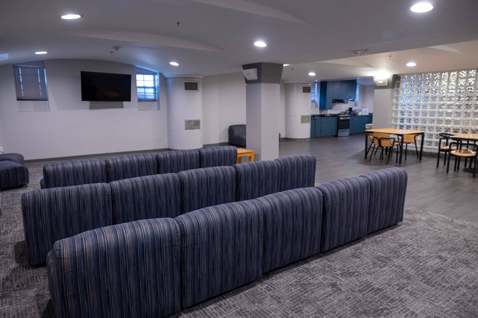 a room with blue chairs and a table