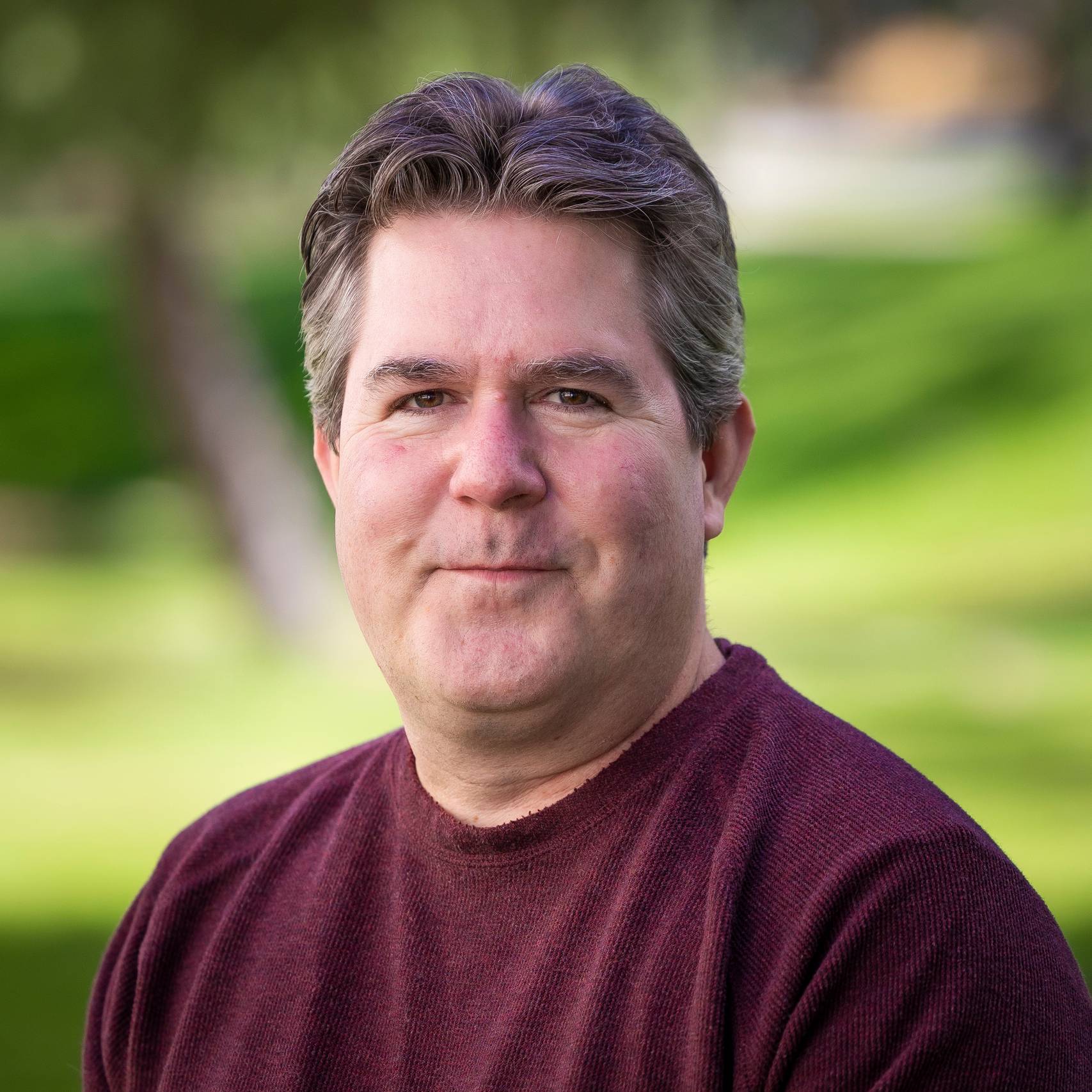 a person in a maroon shirt