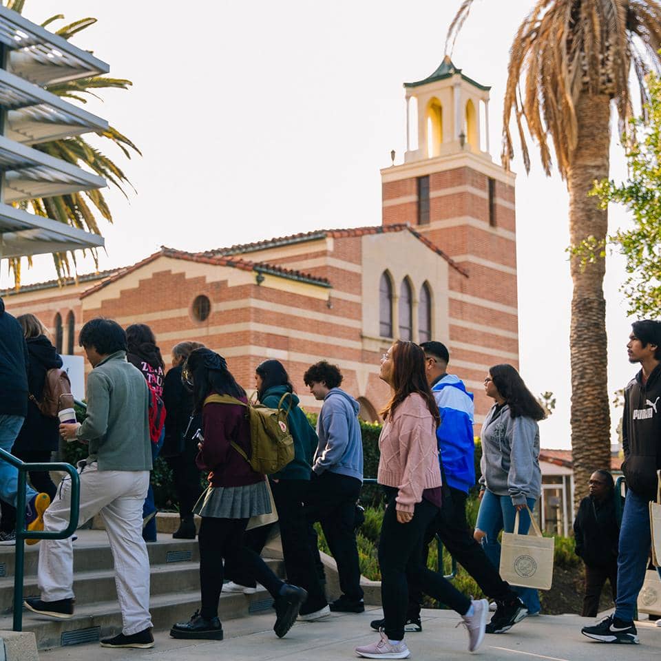 a group of people walking up stairs outside a building