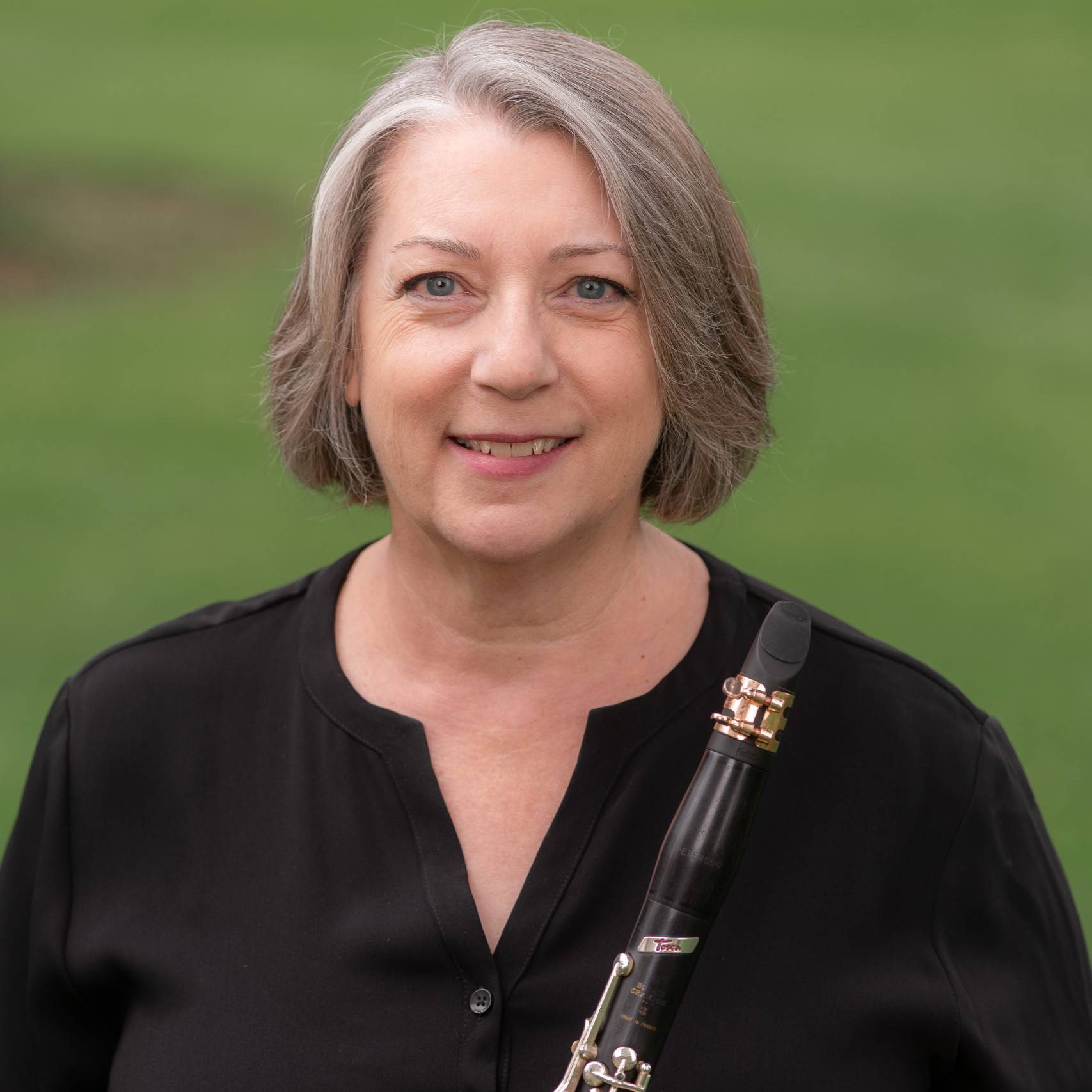 a person holding a clarinet