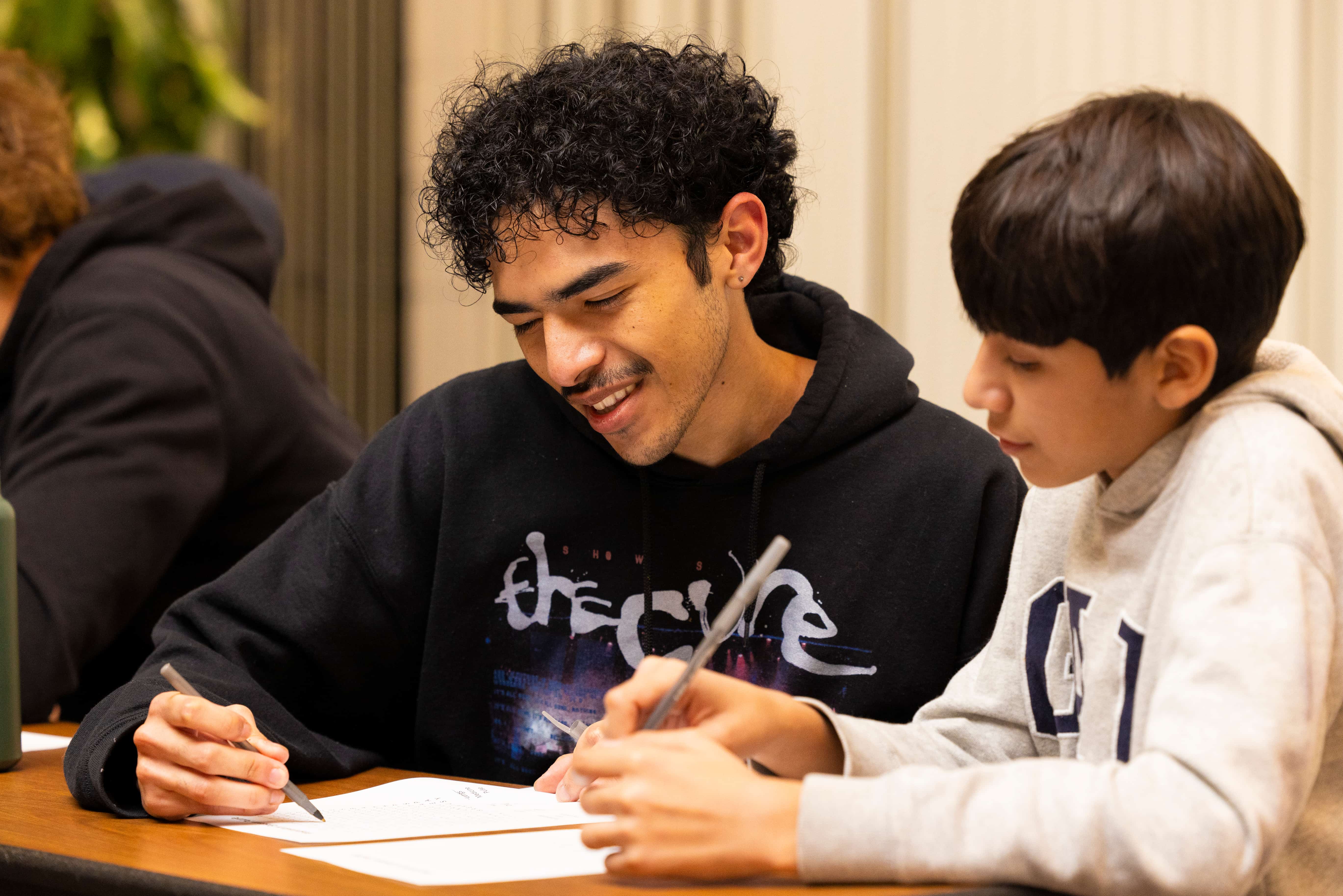 a person writing on a piece of paper
