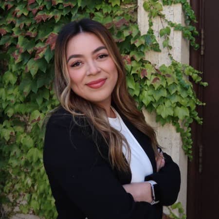 a person standing in front of a wall with ivy