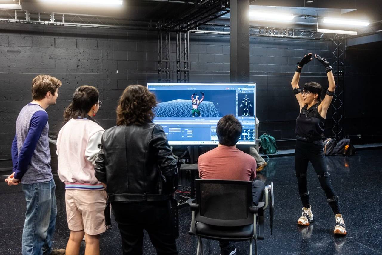 a group of people looking at a person in a room