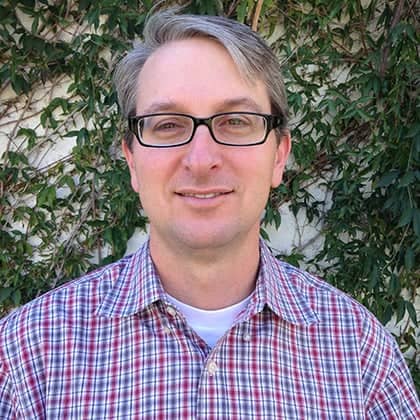 a person wearing glasses and a plaid shirt