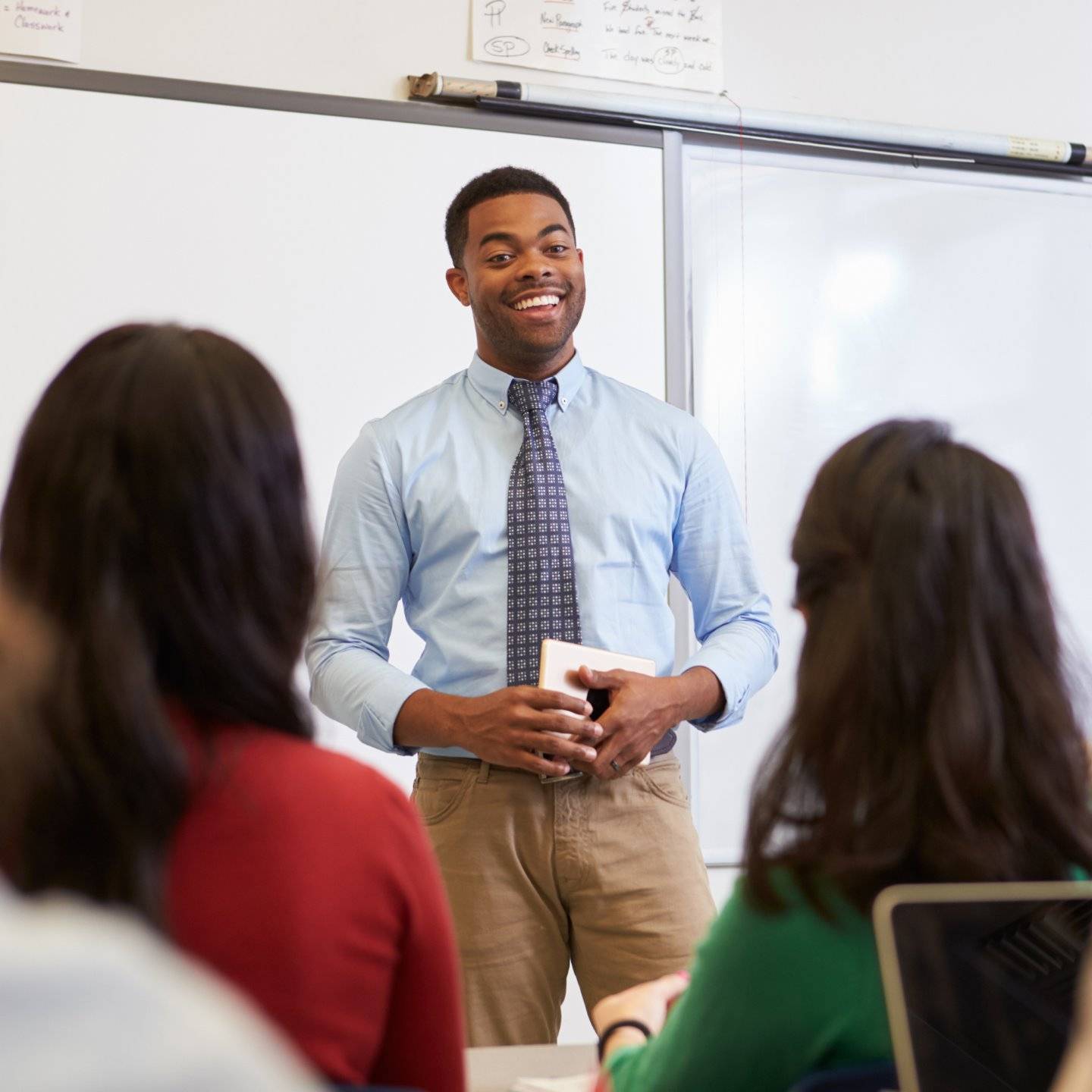 a person standing in front of a whiteboard