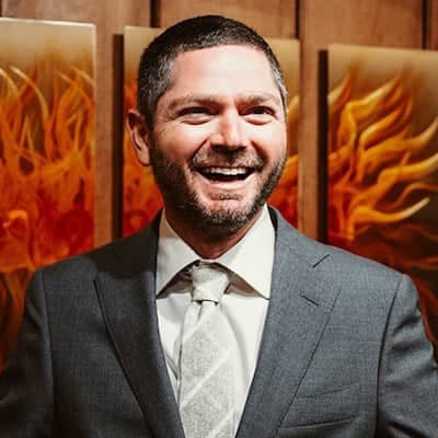 a person in a suit smiling
