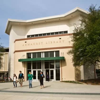 a group of people walking outside of a library