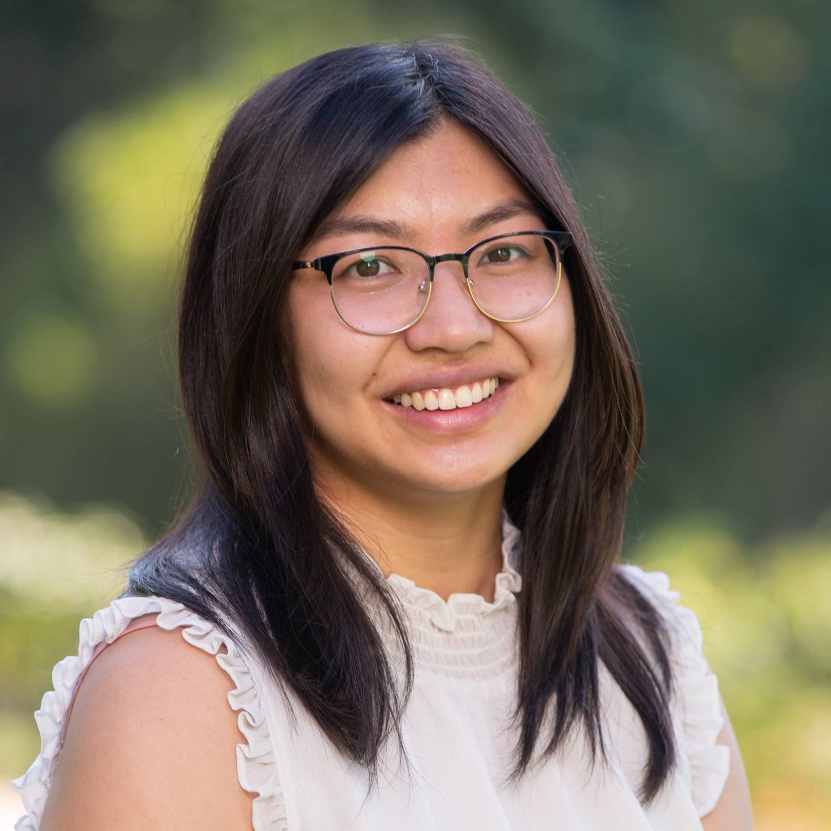 a person wearing glasses smiling