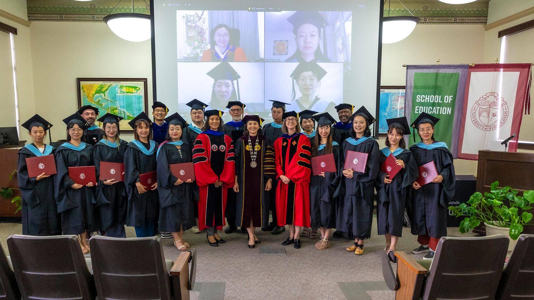 a group of people in graduation gowns and caps
