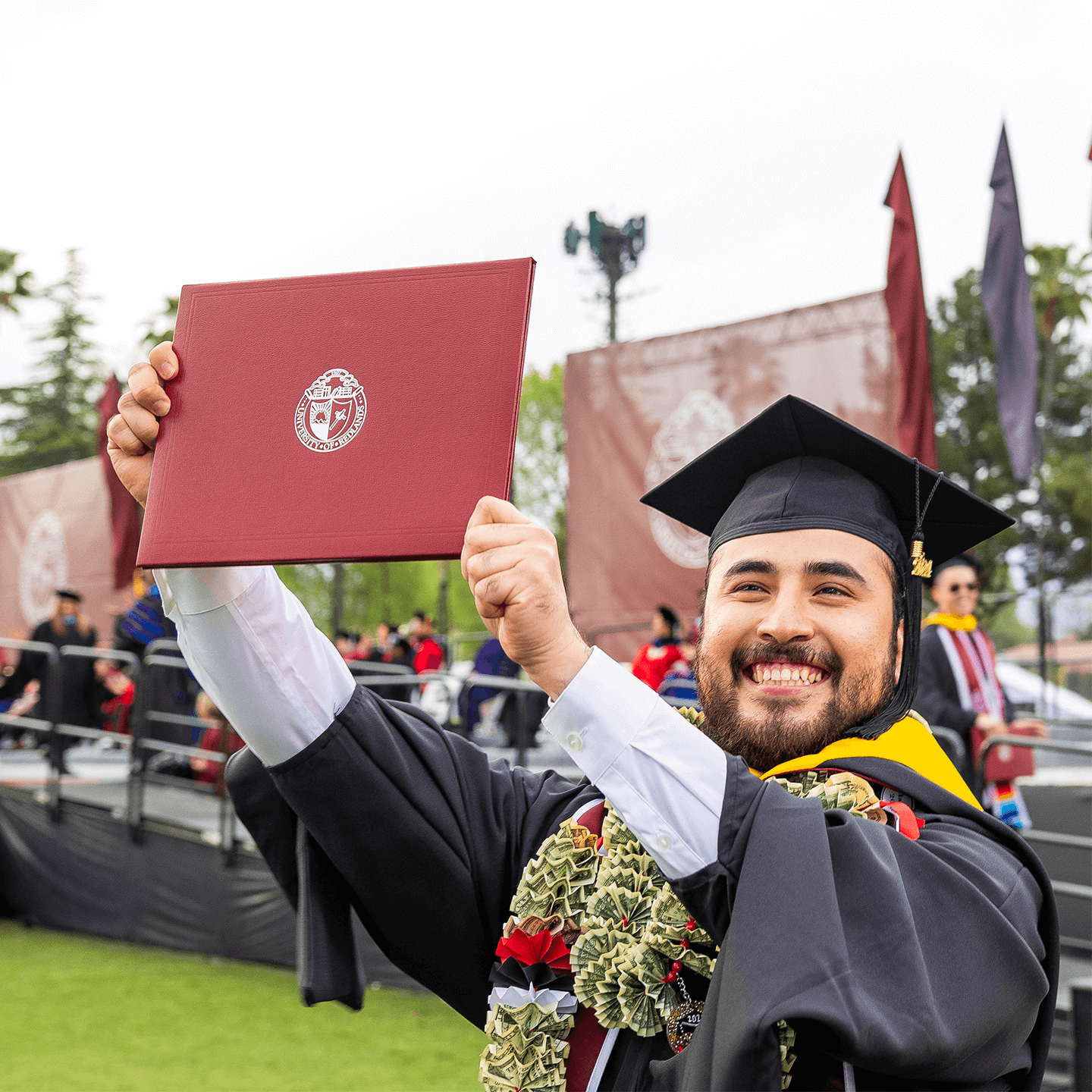 a person in a graduation gown holding a diploma