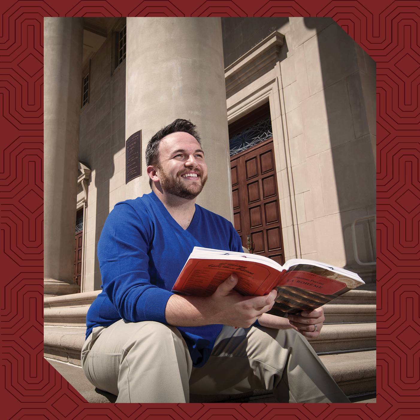 a person sitting on steps holding a book