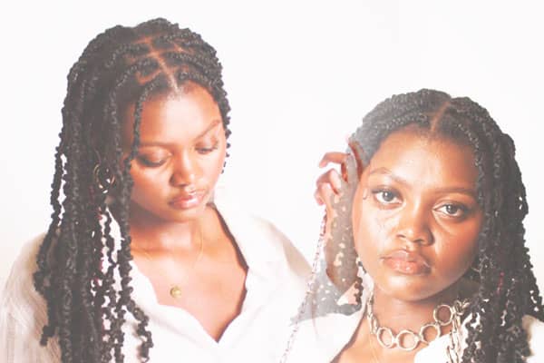 a person with braids and necklaces