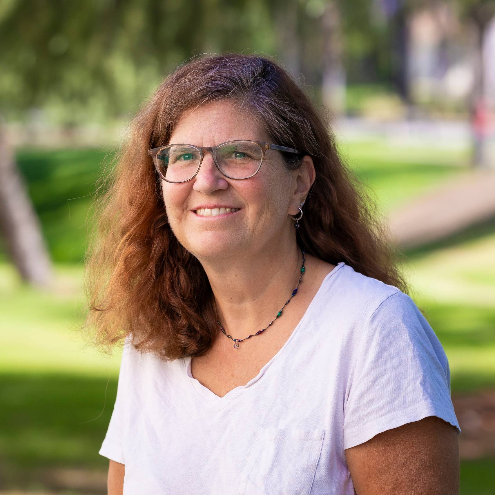 a person wearing glasses and a white shirt