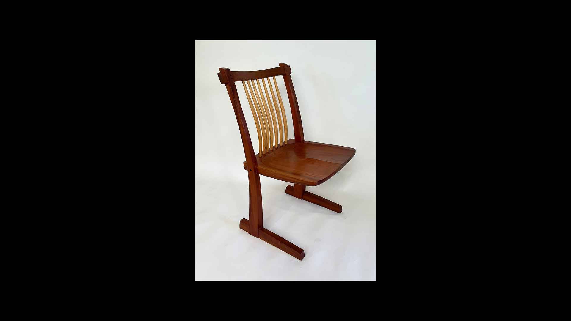 a wooden chair with a black background