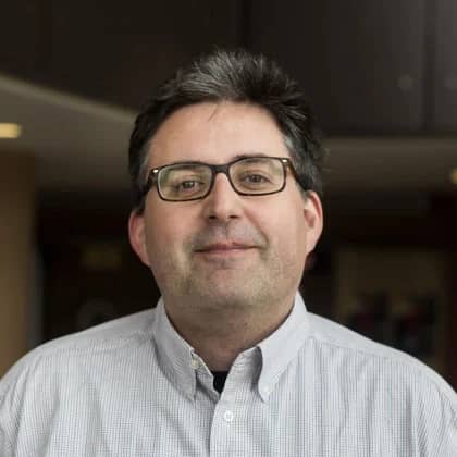 a person wearing glasses and a button up shirt