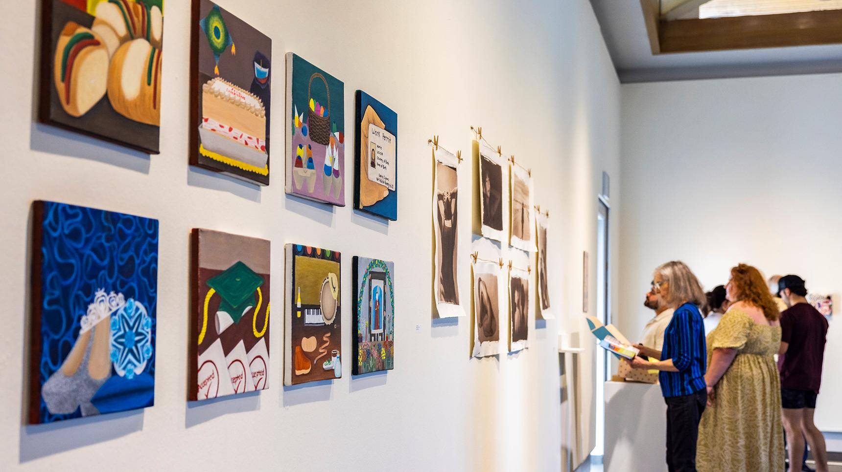 a person looking at pictures on a wall