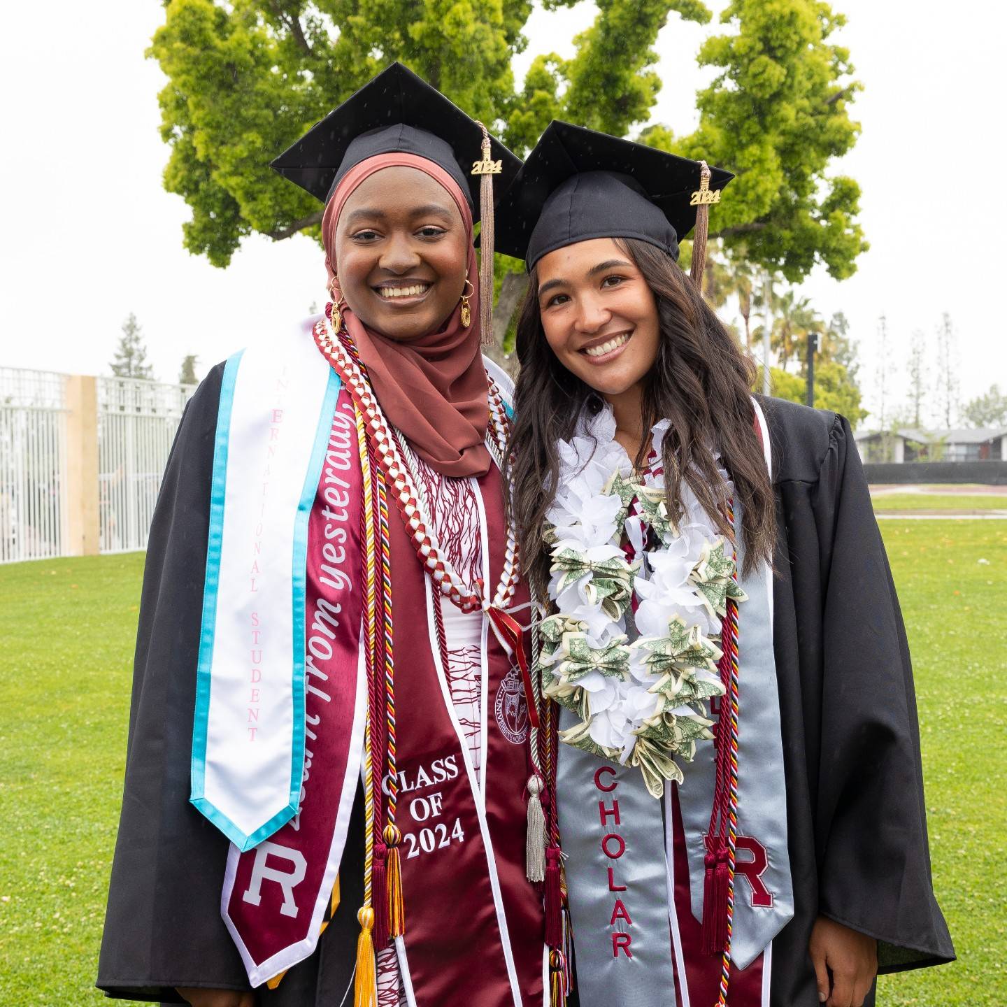a couple of women wearing graduation caps and gowns