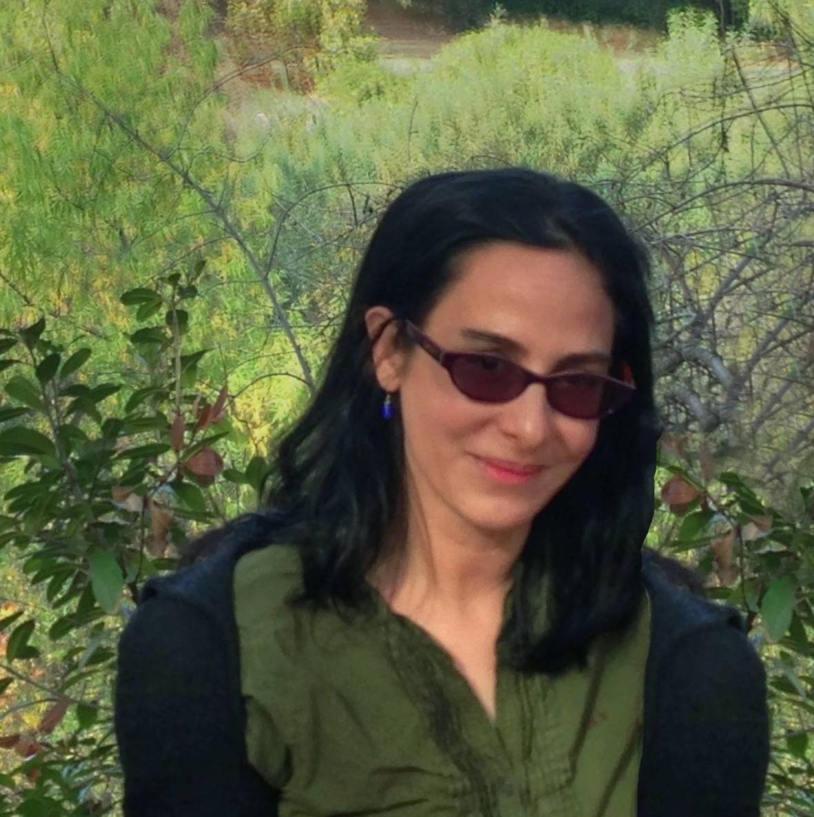 a person wearing sunglasses and smiling