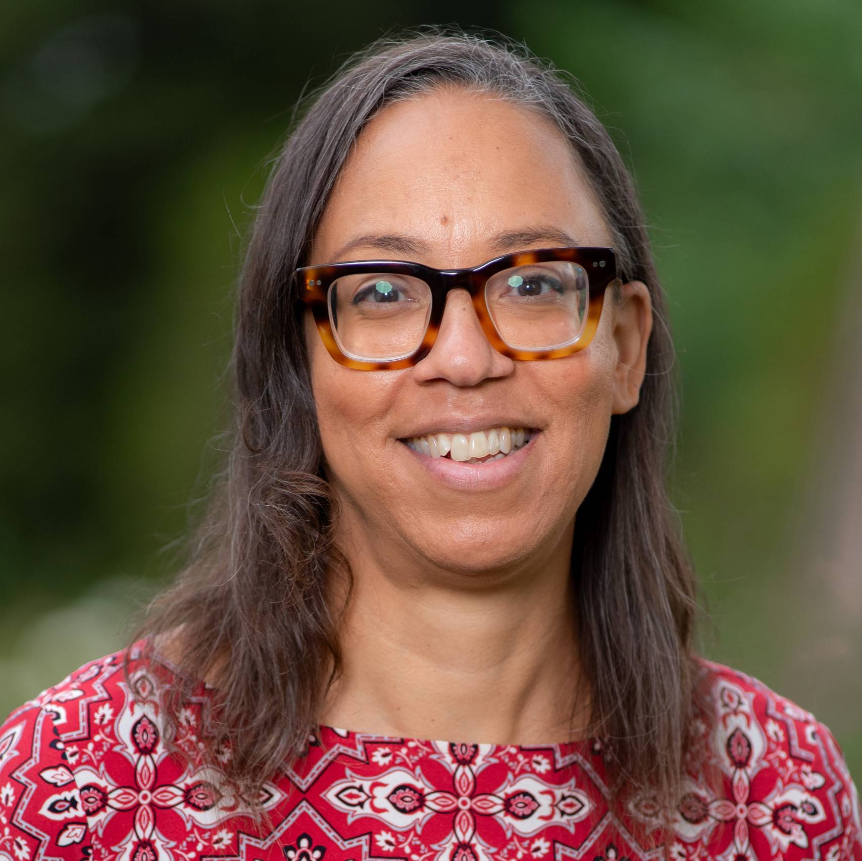 a person wearing glasses smiling