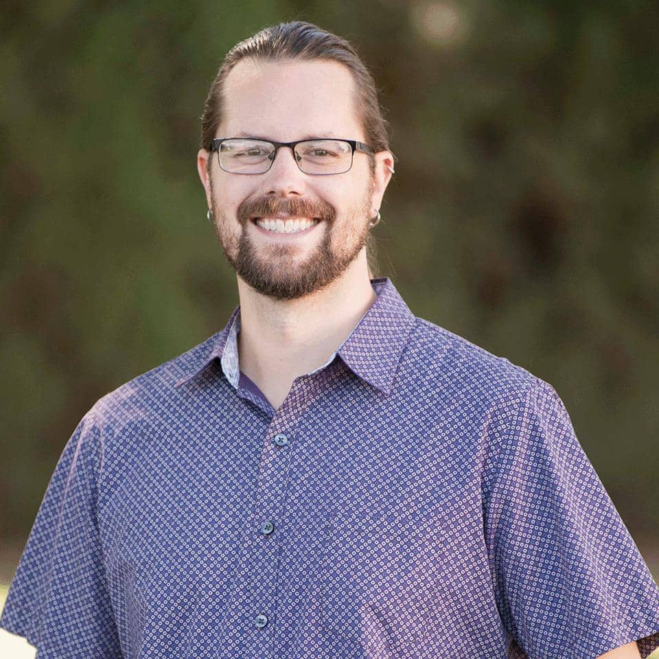 a person wearing glasses and a blue shirt