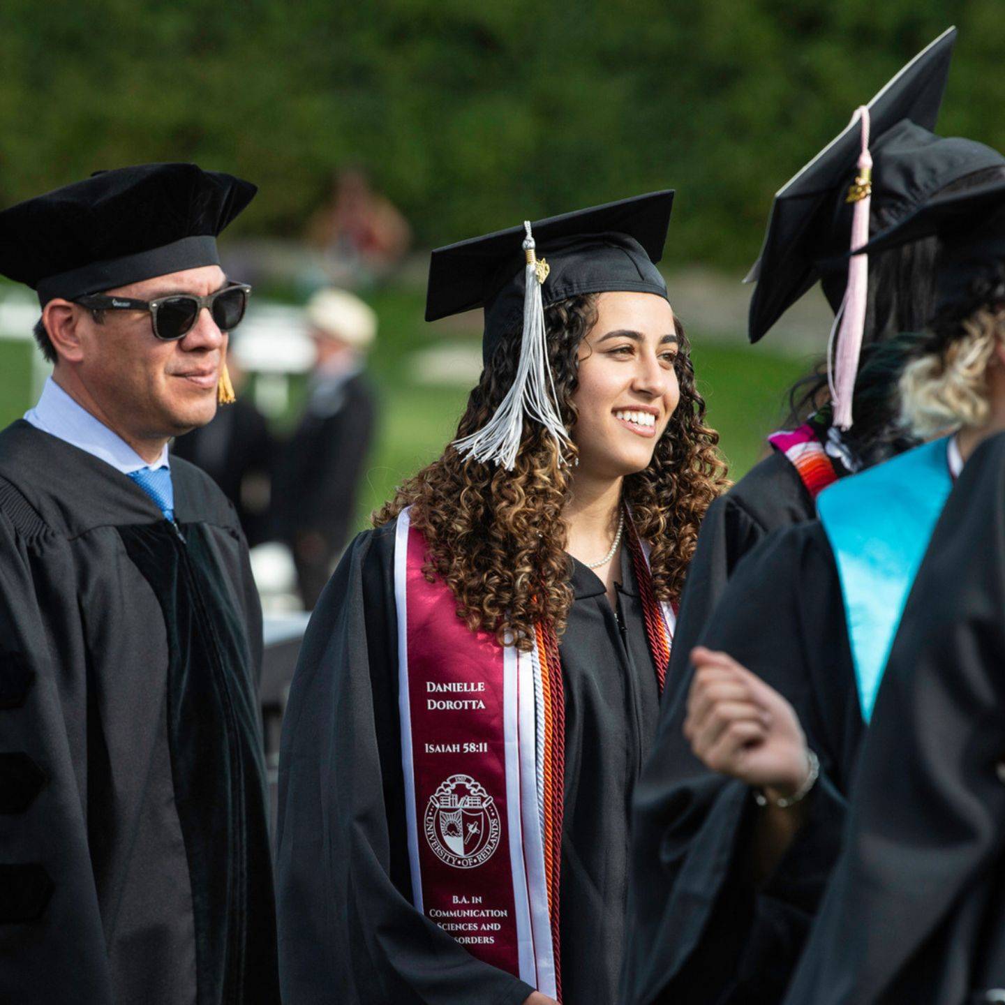 a group of people in graduation gowns and caps
