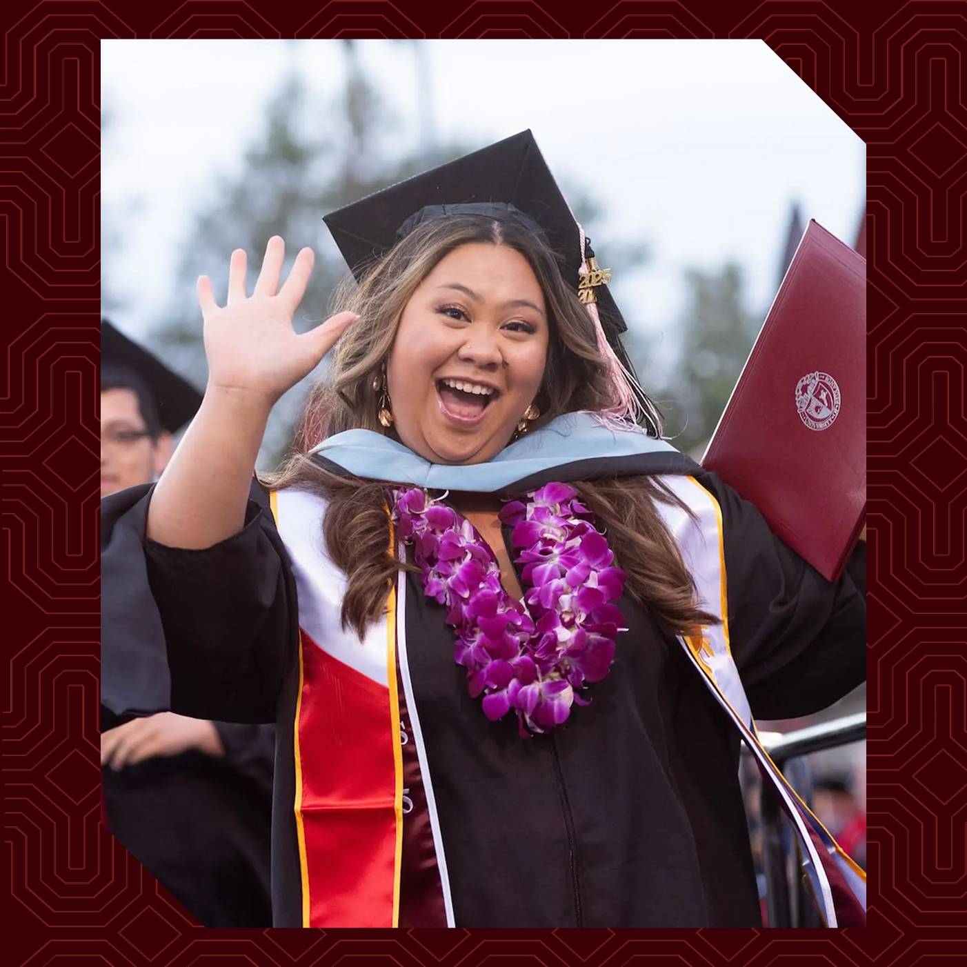Emily Dominguez ’25 celebrating graduation in cap and gown.