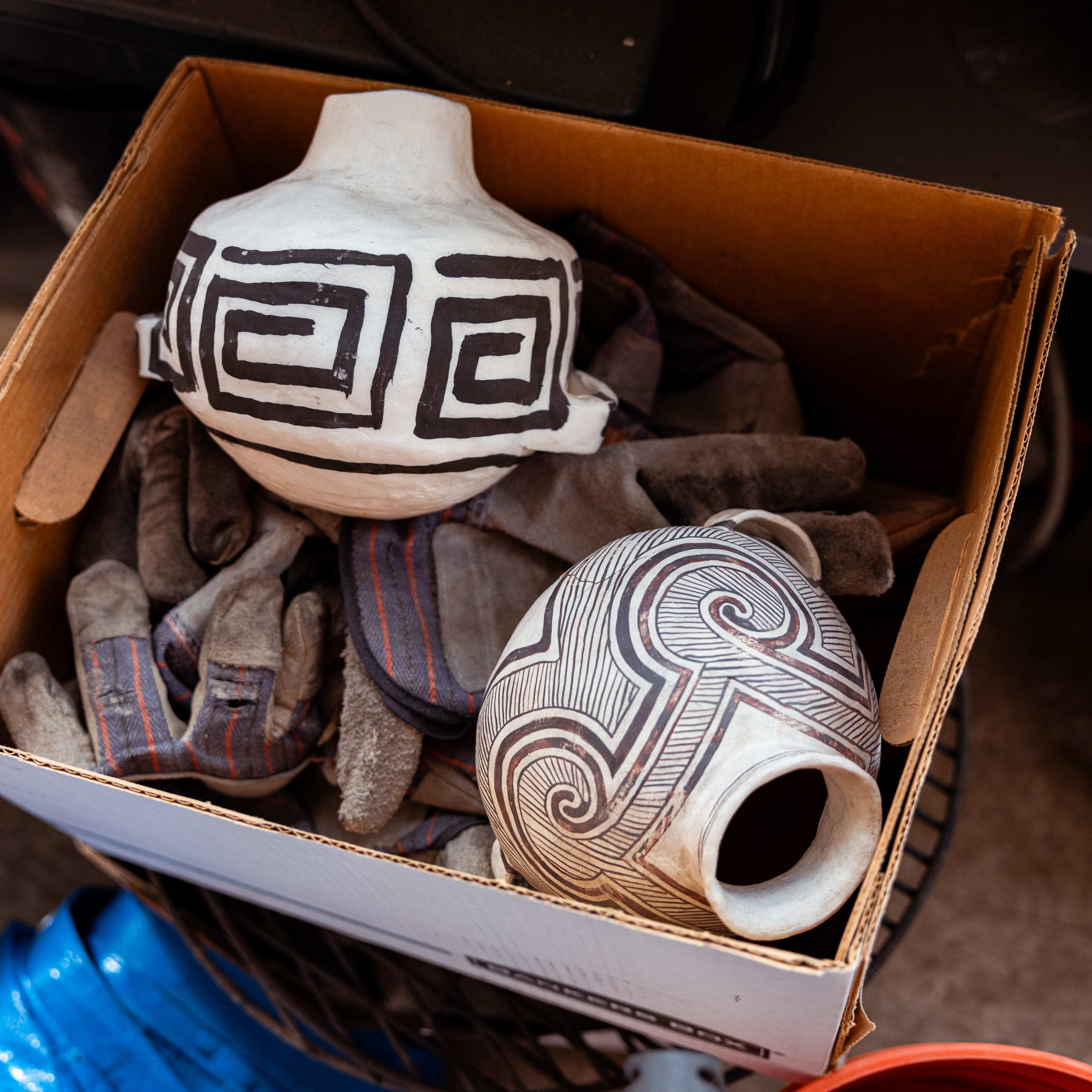 a box with a vase and gloves