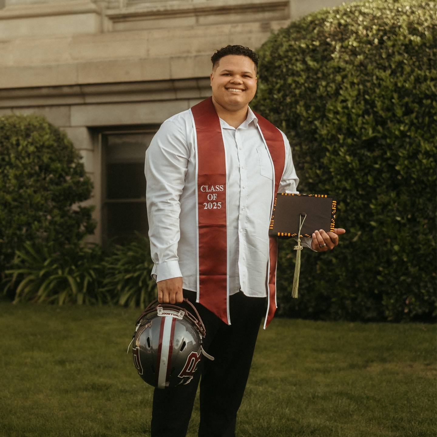 a person wearing a graduation cap and a red and white scarf